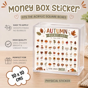May include: A clear acrylic square money box featuring an Autumn Bucket List vinyl sticker. The sticker displays 50 small seasonal icons with currency values from £1 to £50, totalling £500. The box measures 10 x 10 cm and includes text labels.