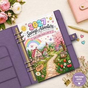 May include: A purple six-ring binder containing a 2027 Savings Adventure insert. The page features a colourful illustration of a whimsical village, a rainbow, a stone path, and the text 2027 Savings Adventure, Save a little, dream a lot!