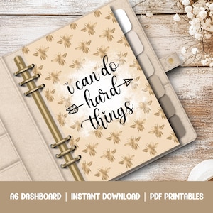 May include: A printable A6 dashboard with a beige background and a gold bee pattern. The text "i can do hard things" is written in black cursive with an arrow pointing to the right.