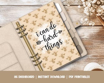 May include: A printable A6 dashboard with a beige background and a gold bee pattern. The text "i can do hard things" is written in black cursive with an arrow pointing to the right.