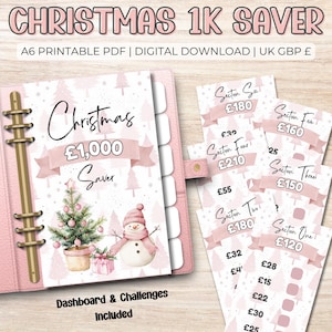 May include: A pink Christmas-themed savings planner with a binder and challenge cards. The cover features a Christmas tree, snowman, and the text "Christmas £1,000 Saver". The challenge cards have sections with amounts to save.