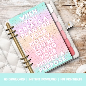 May include: A pink, blue, and yellow printable A6 dashboard with the text "WHEN YOU CREATE A PLAN FOR YOUR MONEY, YOU'RE GIVING YOUR MONEY A PURPOSE." The dashboard has a gold spiral binding and colorful dividers.