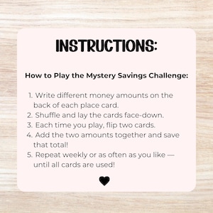Op de afbeelding: Een lichtroze vierkante kaart met afgeronde hoeken en zwarte tekst: INSTRUCTIONS: How to Play the Mystery Savings Challenge: 1. Write different money amounts on the back of each place card. 2. Shuffle and lay the cards face-down. 3. Each time you play, flip two cards. 4. Add the two amounts together and save that total! 5. Repeat weekly or as often as you like &mdash; until all cards are used! Een klein zwart hartje staat onderaan.