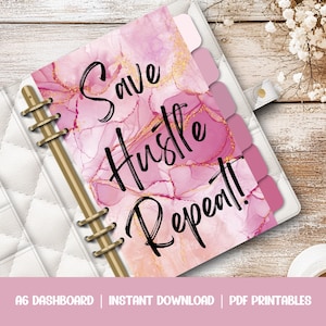 May include: An A6 planner with a pink and gold marble pattern, gold rings and dividers. The planner has the text "Save Hustle Repeat!" in black lettering.
