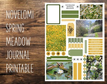 May include: A printable journal page with a spring meadow theme. The design includes floral elements, a field of yellow flowers, and a scenic road. Text includes "NOVELOMI SPRING MEADOW JOURNAL PRINTABLE" and days of the week.