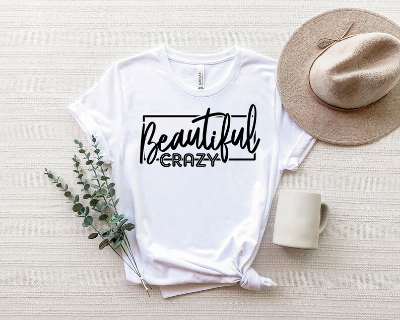 May include: White t-shirt with black text that reads "Beautiful - Crazy" in a rectangle.