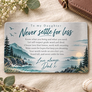 Puede incluir: Una tarjeta de metal rectangular para cartera con un paisaje costero que incluye montañas, pinos y una puesta de sol. El texto dice: To my Daughter, Never settle for less. Know what you bring and what you need; Let self-respect guide word and deed.