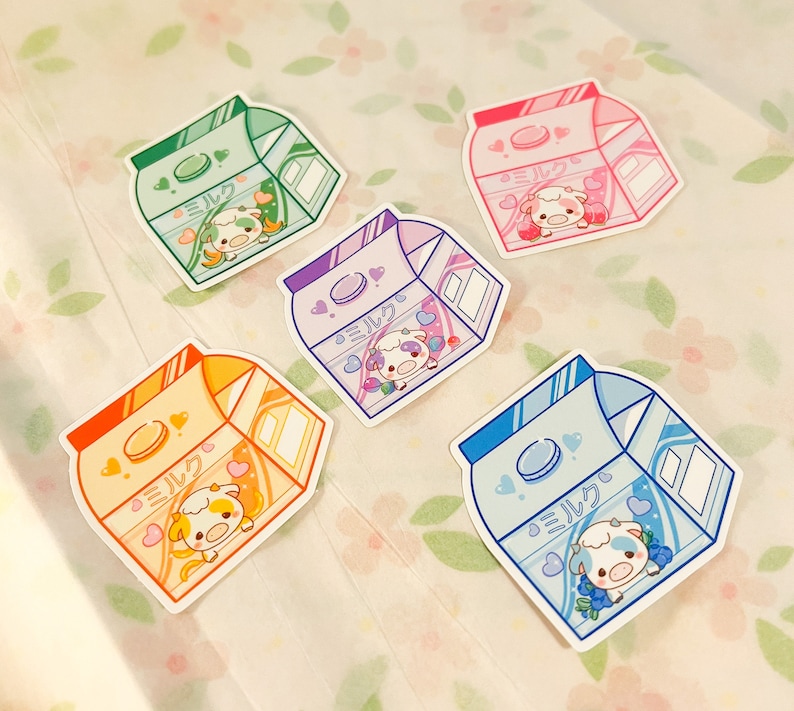 May include: Five colorful milk carton stickers with a cartoon cow and the word "ミルク" (Milk) in Japanese. The stickers are in shades of pink, blue, green, yellow, and orange.
