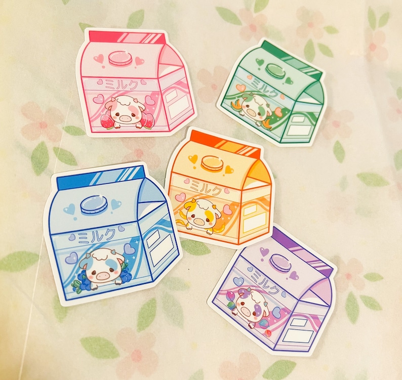 May include: Five colorful milk carton stickers with a cartoon cow and the Japanese word "Milk" on each. The stickers are on a white background with pink flowers.