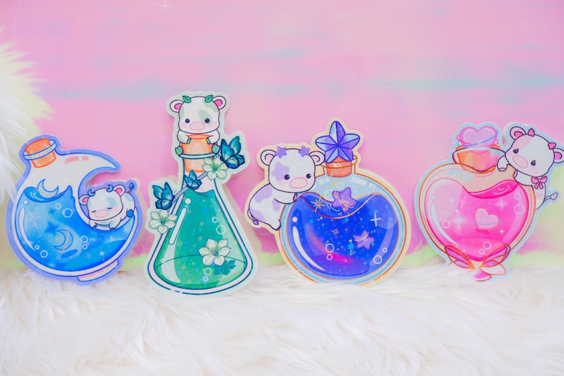 May include: Four colorful glass bottles with cute cartoon cows on top. The bottles are filled with different colored liquids and have a whimsical, magical aesthetic.