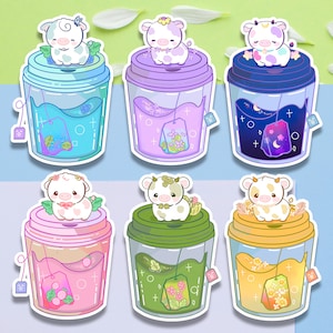 May include: Six illustrated stickers of cute cartoon cows with different colored drinks in to-go cups. The cows are wearing flowers and sitting on the rim of the cups. The drinks are blue, purple, pink, green, and yellow. The stickers are perfect for adding a touch of whimsy to your planner, laptop, or water bottle.
