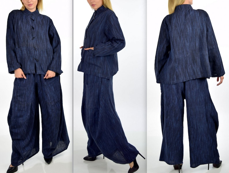 May include: A blue linen pantsuit with a mandarin collar and long sleeves. The jacket has a button closure and the pants have a wide leg.