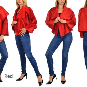 May include: A red cropped jacket with a draped collar and long sleeves. The jacket is worn by a model with blue jeans and black heels. The word "Red" is written in white text below the model.