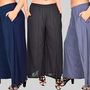 May include: Three pairs of wide-leg pants in navy blue, black, and gray. The pants have a wide, flowing silhouette and a comfortable elastic waistband.