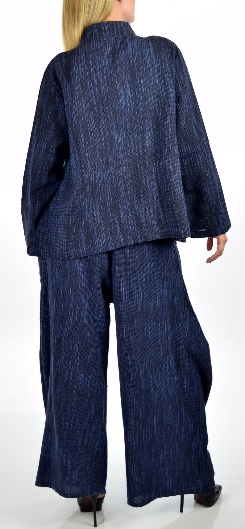 May include: A blue and black patterned long-sleeved top and wide-leg pants set. The top has a mandarin collar and the pants have a wide leg.