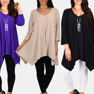 May include: Three women's tops in purple, beige, and black with a long, asymmetrical hemline. Each top has a v-neck and three-quarter sleeves. The tops are paired with leggings or pants.