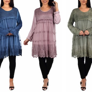 May include: Three long-sleeved tunics with lace detailing. The tunics are in shades of blue, pink, and green.