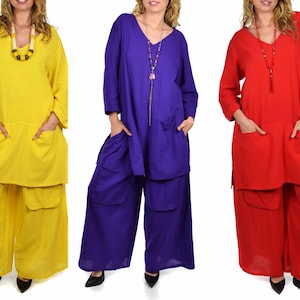 May include: Three women are wearing matching outfits with long sleeves and pants. The outfits are in three different colors: yellow, purple, and red. The outfits have pockets on the front and back.