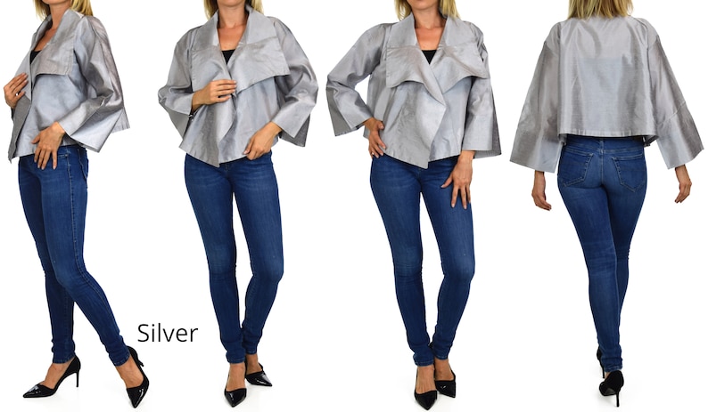 May include: A silver jacket with a draped collar and wide sleeves. The jacket is shown on a model wearing blue jeans and black heels. The word "Silver" is written in white text below the model.