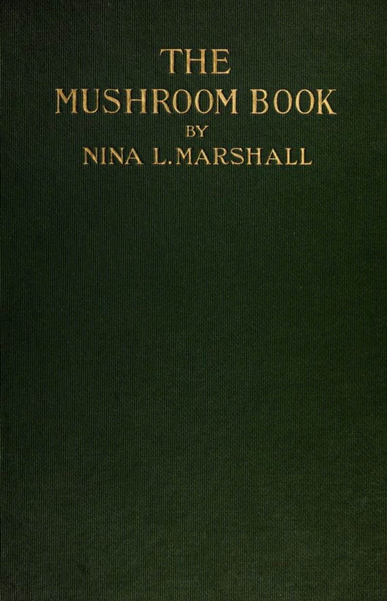 May include: The cover of a green book with gold lettering that reads "THE MUSHROOM BOOK BY NINA L. MARSHALL"
