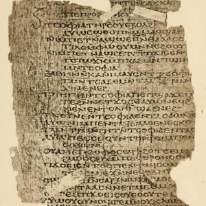May include: A fragment of a papyrus scroll with ancient Greek text written in black ink. The text is partially obscured by damage to the papyrus. The scroll is likely from the 1st or 2nd century CE.