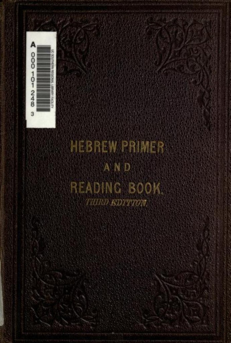 May include: A dark brown hardcover book titled HEBREW PRIMER AND READING BOOK. THIRD EDITION in gold lettering. The cover features a textured leather-like surface with embossed floral corner details and a white barcode label in the top left corner.