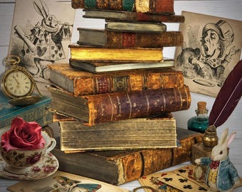 May include: A stack of antique leather-bound books surrounded by Alice in Wonderland themed items including a pocket watch, a teacup with a red rose, playing cards, a small rabbit figurine, a dark feather quill, and vintage illustrations.
