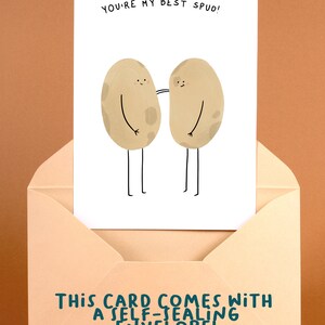 May include: A greeting card with the text "YOU'RE MY BEST SPUD!" features two cartoon potatoes with arms and legs. The card is inside a peach-colored envelope. The envelope text reads "THIS CARD COMES WITH A SELF-SEALING ENVELOPE!"