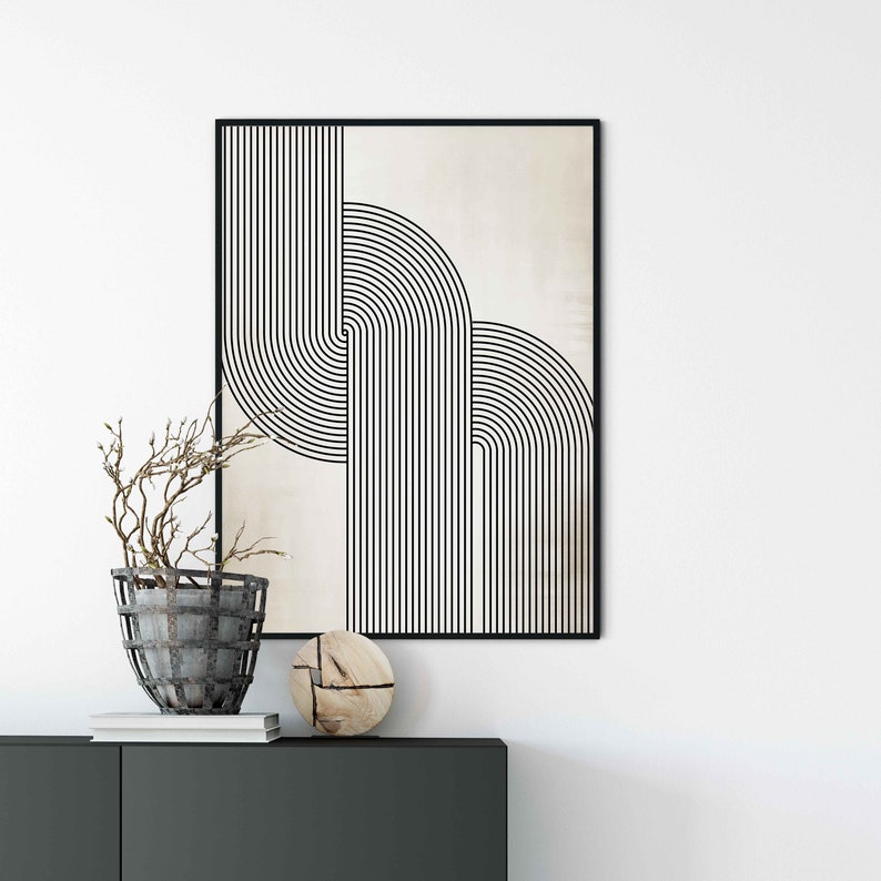 May include: Black and white abstract geometric print with a beige background. The print features overlapping curved lines and is framed in a black frame.