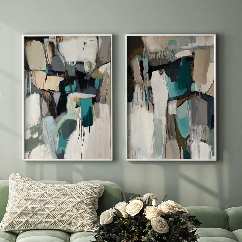 May include: Two abstract paintings with white frames. The paintings are both in shades of white, gray, brown, and teal. The paintings are side by side on a wall.