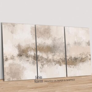 May include: A three-panel abstract art print with a beige and brown color scheme. The print features a watercolor-like effect with soft, flowing lines and shapes. The print is titled "line form" and is printed on paper and shipped.