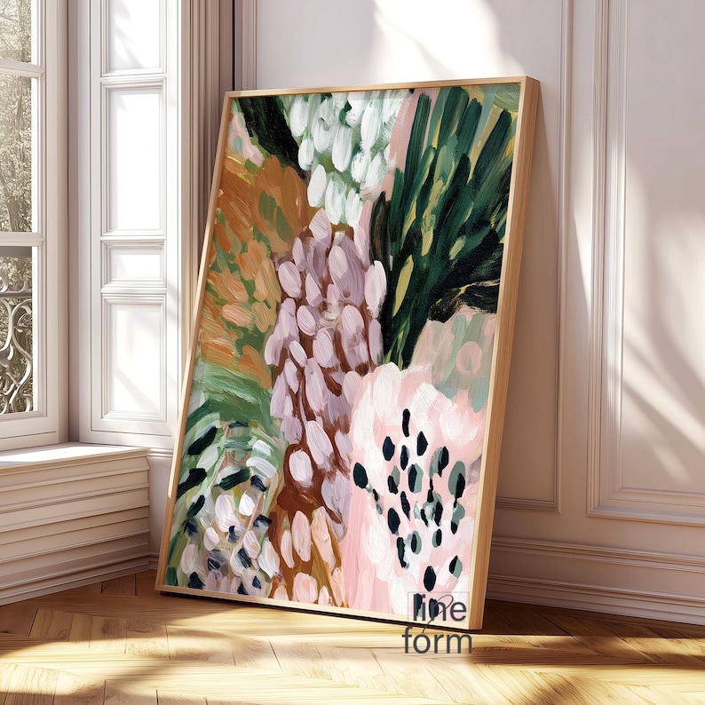 May include: Abstract art print with a wooden frame. The artwork features a colorful floral design with brushstrokes in shades of pink, green, white, and brown. The painting is leaning against a white wall and a window.
