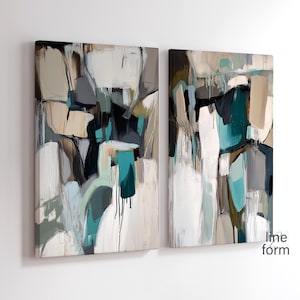 May include: Two abstract paintings with a white background and splashes of teal, brown, and black paint. The paintings are framed and ready to hang.