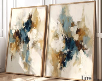 Puede incluir: Dos pinturas abstractas enmarcadas. La obra presenta una mezcla de colores, incluyendo tonos de azul, marrón y dorado, sobre un fondo blanco. Las pinturas están en marcos de madera, apoyadas contra una pared. El estilo es moderno y artístico.