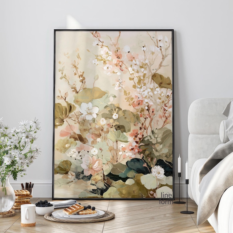 May include: A framed floral art print featuring a soft color palette of cream, pink, and green. The artwork depicts a botanical scene with various flowers and foliage. The print is encased in a black frame, adding a touch of elegance to the piece.