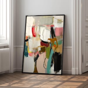 Puede incluir: Impresi&oacute;n art&iacute;stica abstracta en un marco negro. La obra presenta una mezcla de colores, incluyendo rojo, rosa, negro y turquesa, con pinceladas y formas. La pintura se apoya en una pared blanca y un suelo de madera.