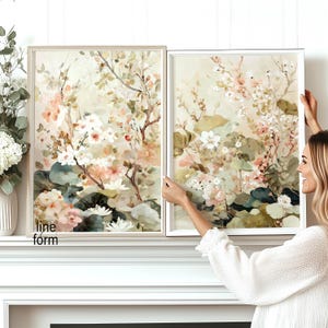 May include: Two framed floral art prints. The artwork features a watercolor style with soft pink, white, and green flowers and foliage. The frames are a light neutral color. The text "line form" is visible on the left frame.