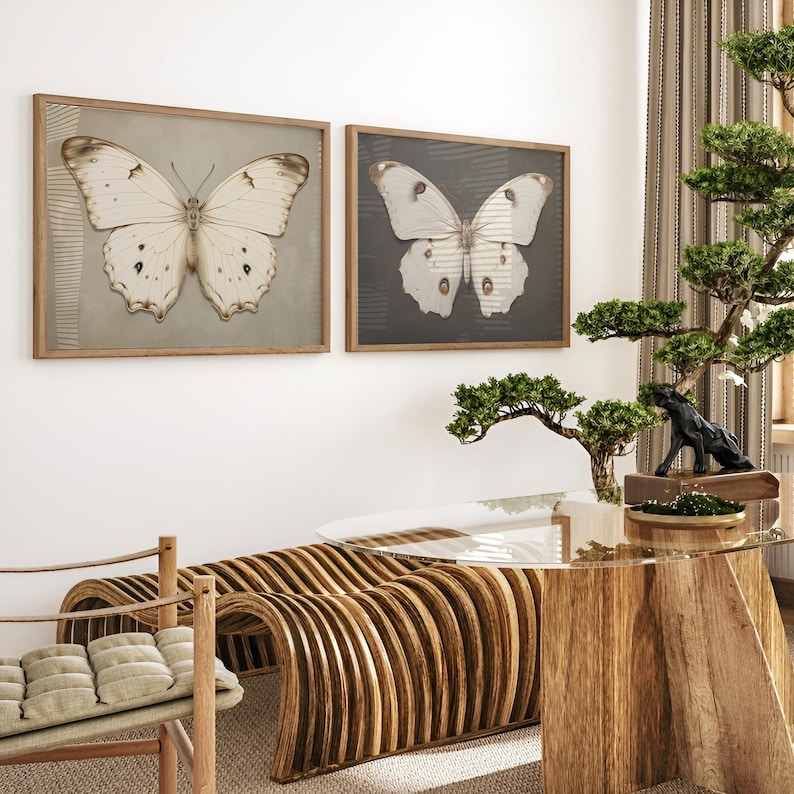 May include: Two framed prints of white butterflies with brown markings on a light brown background. The prints are hanging on a white wall above a wooden table with a glass top. A bonsai tree with green leaves is in a pot on the table.