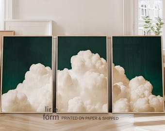 May include: Three framed prints with a dark green background and white clouds. The prints are arranged in a row, with the clouds overlapping each other.