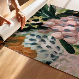 May include: An abstract floral art print with a palette of pink, green, and blue hues. The artwork is being unrolled on a wooden surface, revealing the brushstroke details and the "line form" logo.