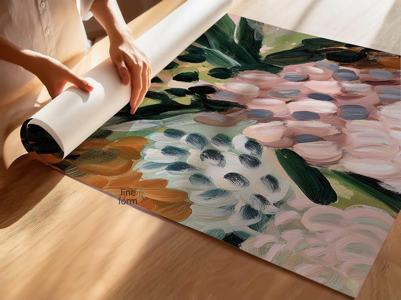 May include: An abstract floral art print with a palette of pink, green, and blue hues. The artwork is being unrolled on a wooden surface, revealing the brushstroke details and the "line form" logo.