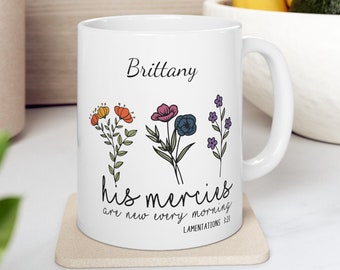 May include: White ceramic mug with a floral design and the text "his mercies are new every morning" and "Lamentations 3:23". The mug also has the name "Brittany" printed on it.