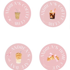 May include: Four pink circle stickers with white text and illustrations. The stickers say "Andrea's Coffee Club" with a cup of iced coffee, "Andrea's Coffee Club" with a cup of iced coffee with a pink ribbon, "Andrea's Cafe Day" with a cup of iced coffee with a pink ribbon, and "Andrea's Home Cafe" with a croissant with a pink ribbon.