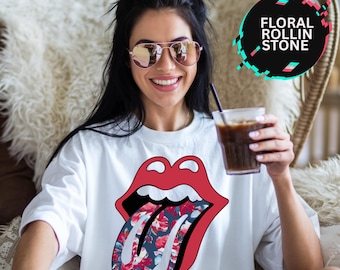 May include: White t-shirt with a red and white graphic of a tongue with a floral pattern. The text "Floral Rollin Stone" is in a circle in the top right corner of the image.