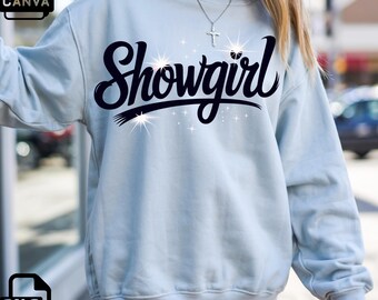 May include: A light blue sweatshirt with the word "Showgirl" in a black script font. The word has a decorative underline and starburst accents. The sweatshirt is a crew neck style.