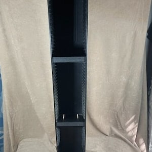 May include: Black plastic CD storage tower with three shelves. The tower is empty and ready to hold CDs.