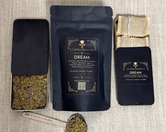 May include: A black pouch and two metal tins labeled Etheria Holistics Dream containing herbal tea blends. The pouch and tins feature text listing ingredients like Asian Blue Lotus, Mugwort, Chamomile, and Mullein. A metal spoon holds loose herbs, and the text 100% Plastic Free Packaging is visible.