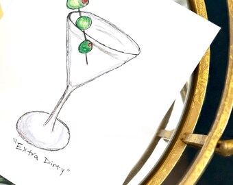 May include: A hand-drawn illustration of a martini glass with three green olives on a cocktail stick. The text "Extra Dirty" is written below the glass.