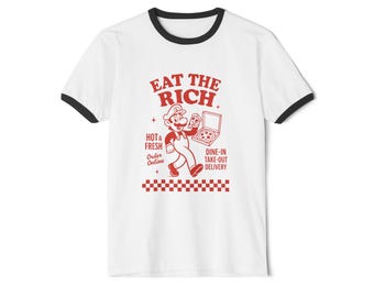 May include: White ringer t-shirt with a black collar and sleeve trim. The shirt features a red graphic of a cartoon character holding a pizza box, with the text "EAT THE RICH". Additional text includes "Hot & Fresh", "Order Online", and "Dine-in Take-out Delivery".