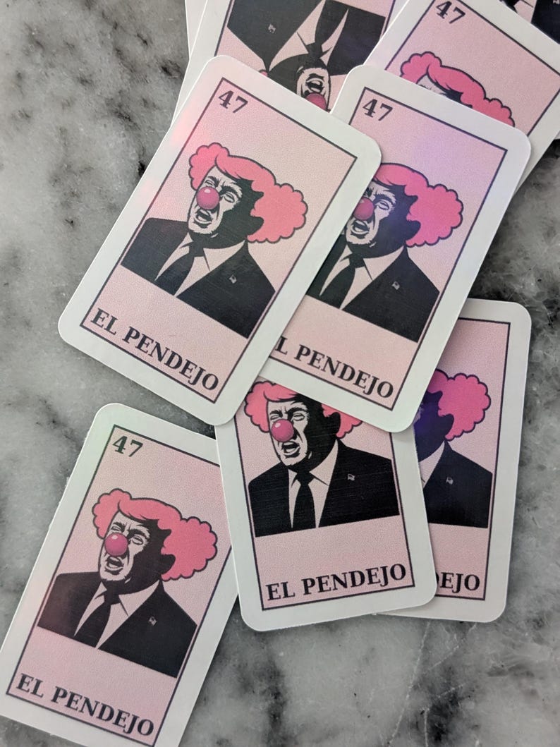 May include: A collection of rectangular cards featuring a caricature of a man with a clown nose and pink hair. The cards have the number "47" in the top corner and the words "EL PENDEJO" at the bottom.